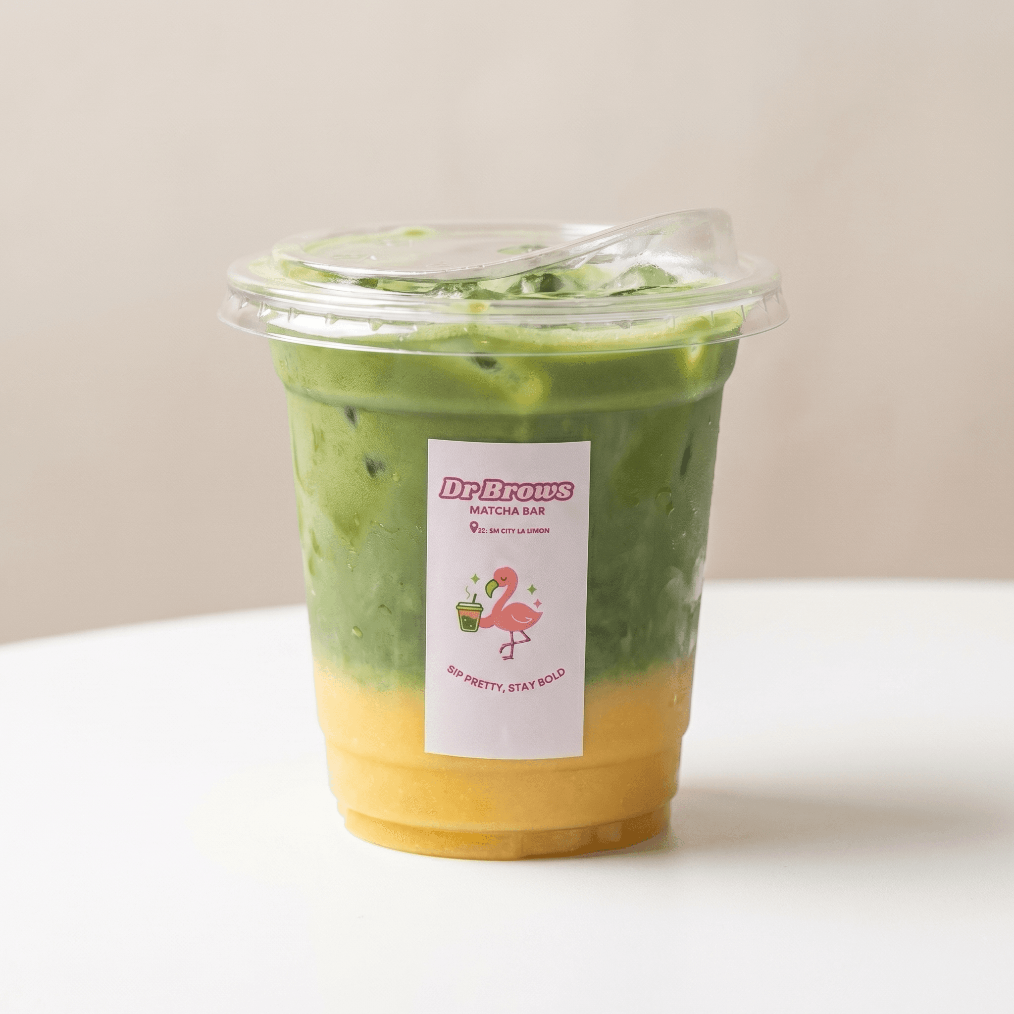 A finished Dr. Brows Matcha Bar iced matcha with the signature flamingo label